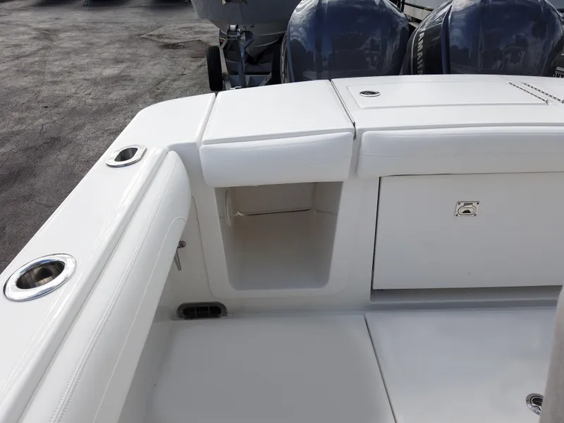 Slide: The Image of 2023 Regulator 28 boat stern with storage compartments and twin outboard motors. - 20