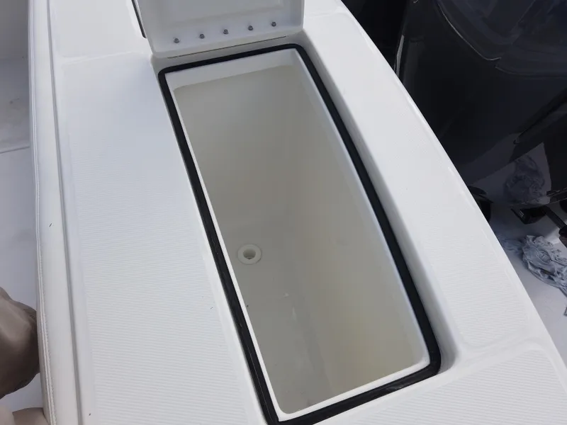 Slide: The Image of Open storage compartment on a 2023 Regulator 28 boat. - 25