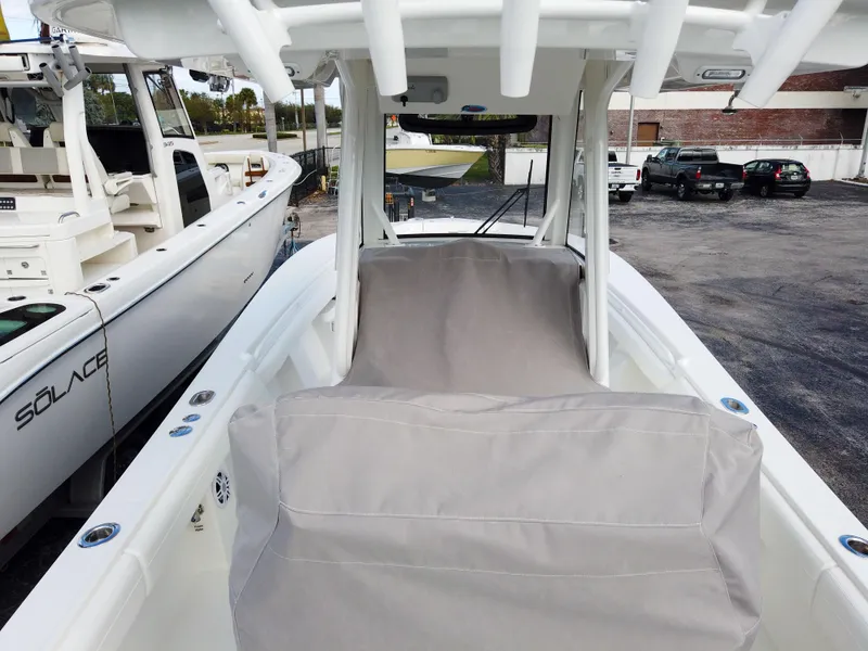 Slide: The Image of 2023 Regulator 28 boat interior with covered seating and white hull. - 26