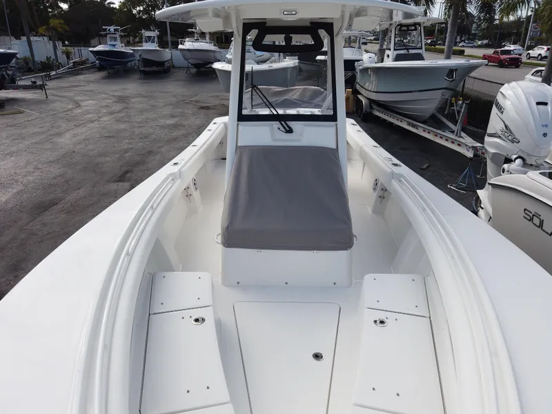 Slide: The Image of 2023 Regulator 28 boat, front deck view with seating and storage compartments. - 29