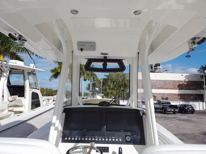 Slide: The Image of 2023 Regulator 28 boat dashboard with dual screens and controls. - 33