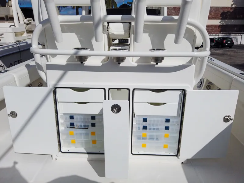 Slide: The Image of 2023 Regulator 28 boat with open storage compartments and tackle boxes. - 34