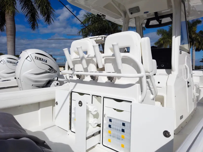 Slide: The Image of 2023 Regulator 28 boat with Yamaha engines, white interior, and fishing rod holders. - 36