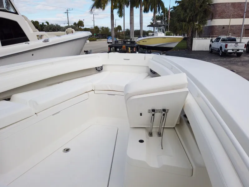 Slide: The Image of 2023 Regulator 28 boat interior with white seating and storage compartments. - 37