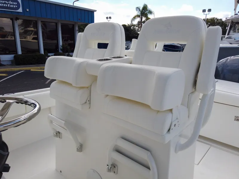 Slide: The Image of 2023 Regulator 28 boat with dual white captain's chairs and stainless steel steering wheel. - 39