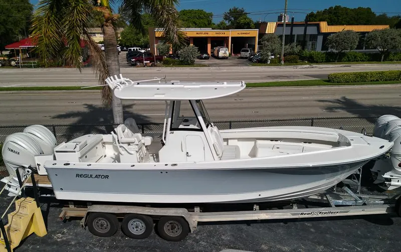 Slide: The Image of 2023 Regulator 28 boat on a trailer, side view, white color. - 4