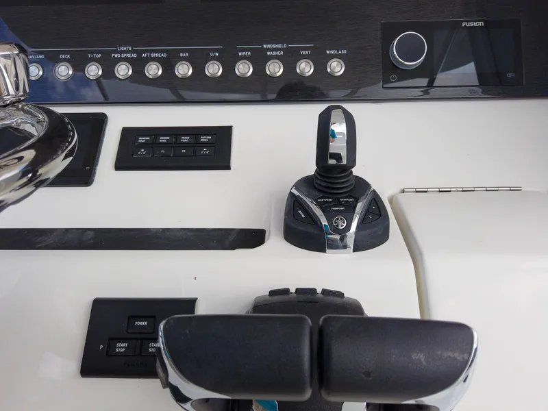 Slide: The Image of Control panel of 2023 Regulator 28 boat with joystick and throttle. - 41