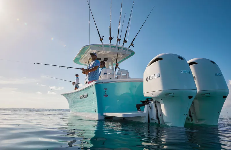 Slide: The Image of 2023 Regulator 28 boat with Yamaha engines, people fishing on calm water. - 44