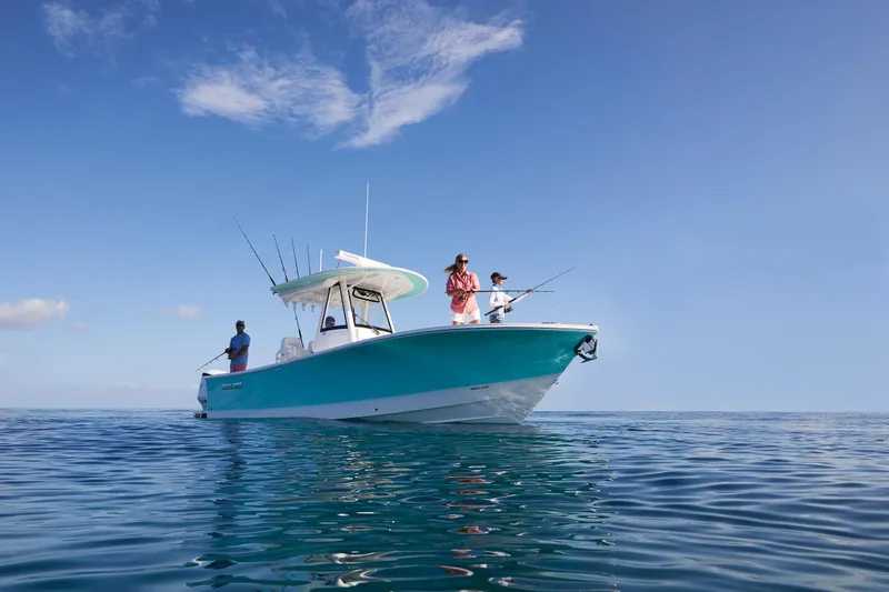 Slide: The Image of 2023 Regulator 28 boat with people fishing on calm ocean waters. - 45