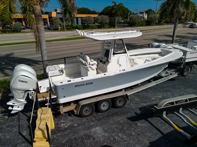 Slide: The Image of 2023 Regulator 28 boat on trailer with Yamaha engines. - 49