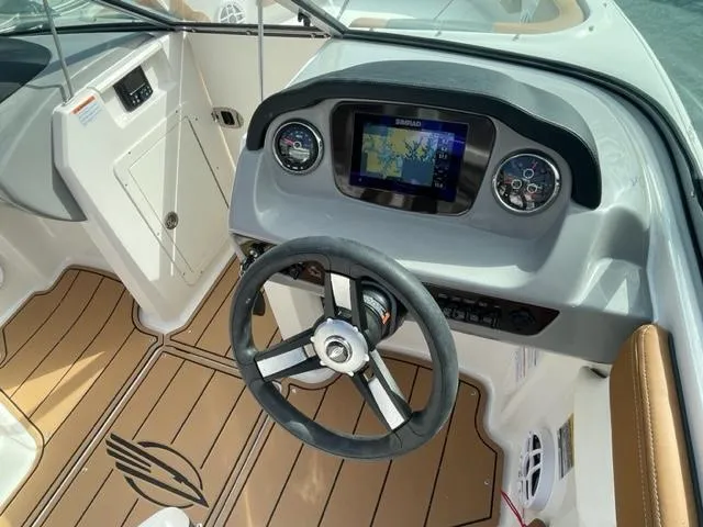 Slide: The Image of 2024 Chaparral 21 SSi boat dashboard with steering wheel and navigation system. - 3