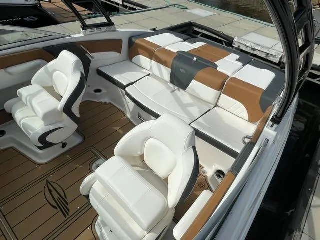 Slide: The Image of 2024 Chaparral 21 SSi boat interior with white and brown seating. - 6