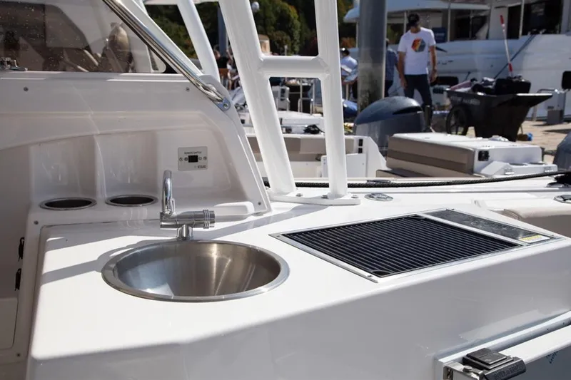 Slide: The Image of 2020 Cutwater 24 DC boat interior with sink and grill setup. - 12