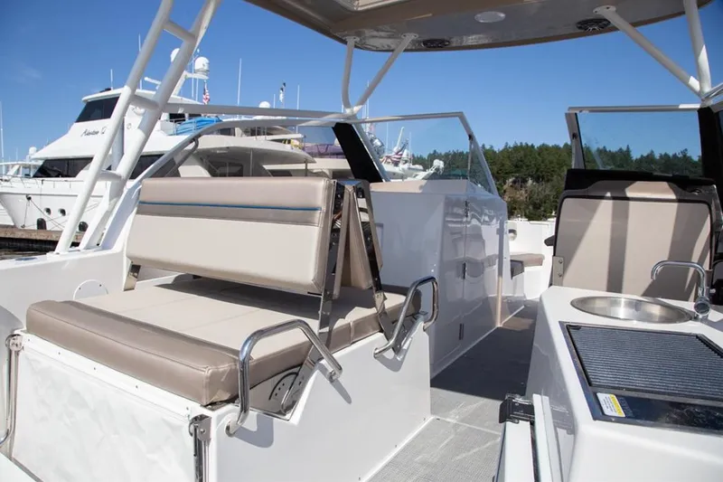Slide: The Image of 2020 Cutwater 24 DC boat interior with seating and console, docked at marina. - 13