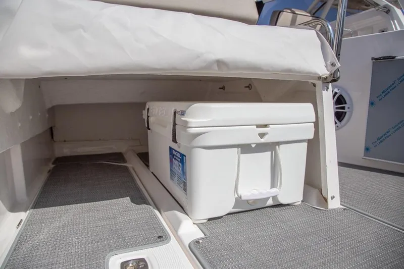 Slide: The Image of 2020 Cutwater 24 DC boat interior with storage compartment and cooler. - 16