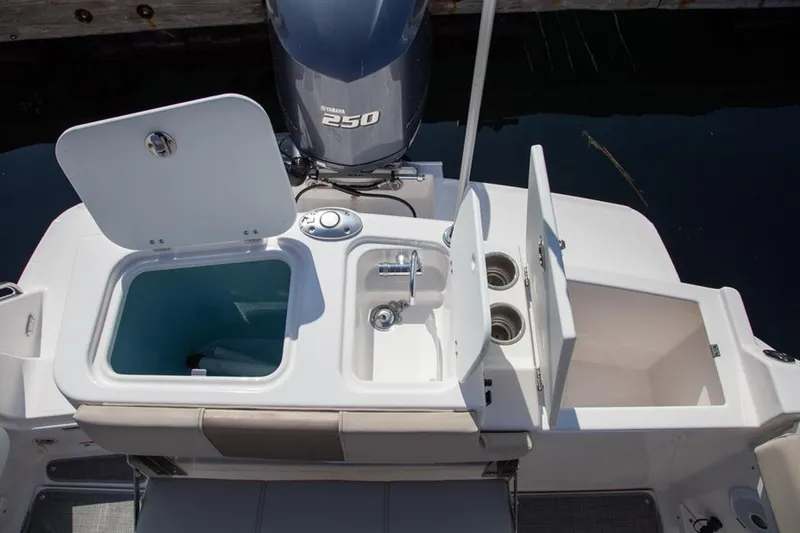 Slide: The Image of 2020 Cutwater 24 DC boat with open storage compartments and Yamaha 250 engine. - 17