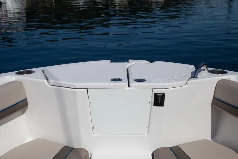 Slide: The Image of 2020 Cutwater 24 DC boat interior with seating and cup holders on calm water. - 5