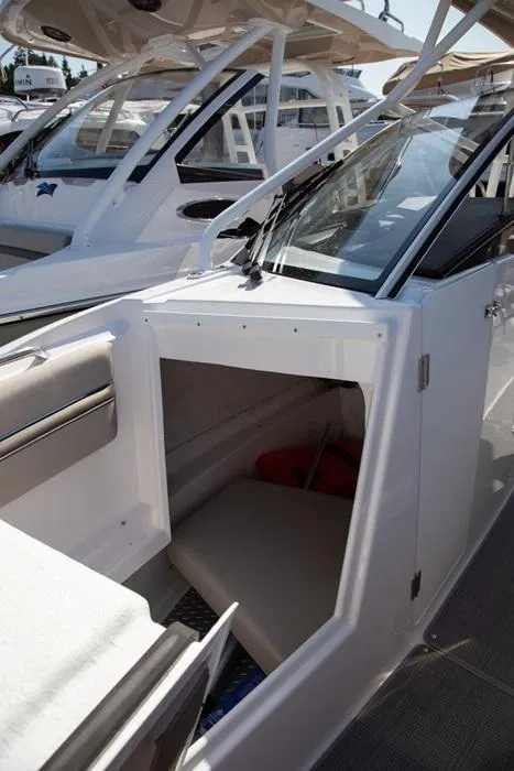 Slide: The Image of 2020 Cutwater 24 DC Dual Console boat interior with open storage compartment. - 7