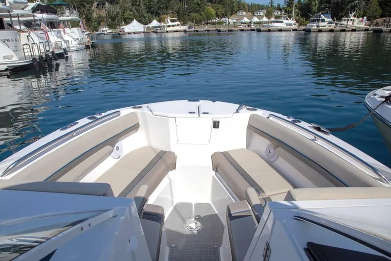 Slide: The Image of 2020 Cutwater 24 DC Dual Console boat interior with seating, docked in a marina. - 8