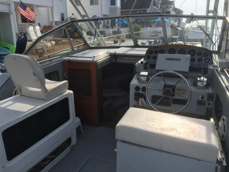 Slide: The Image of 1987 Boston Whaler Cuddy Tower boat interior with steering wheel and seating. - 2