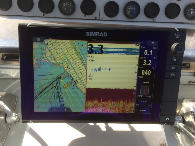 Slide: The Image of Simrad navigation display on 1987 Boston Whaler Cuddy Tower boat dashboard. - 4