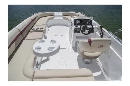 Slide: The Image of 2017 Hurricane SS 201 boat interior with seating, steering wheel, and table on water. - 14