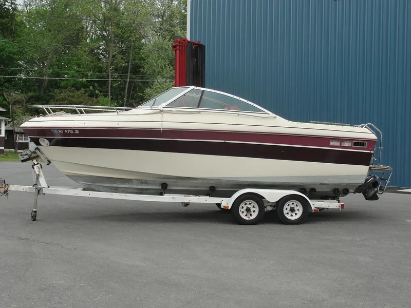 The Image of 1987 Cobalt Condesa boat on a trailer, parked outdoors. - 1