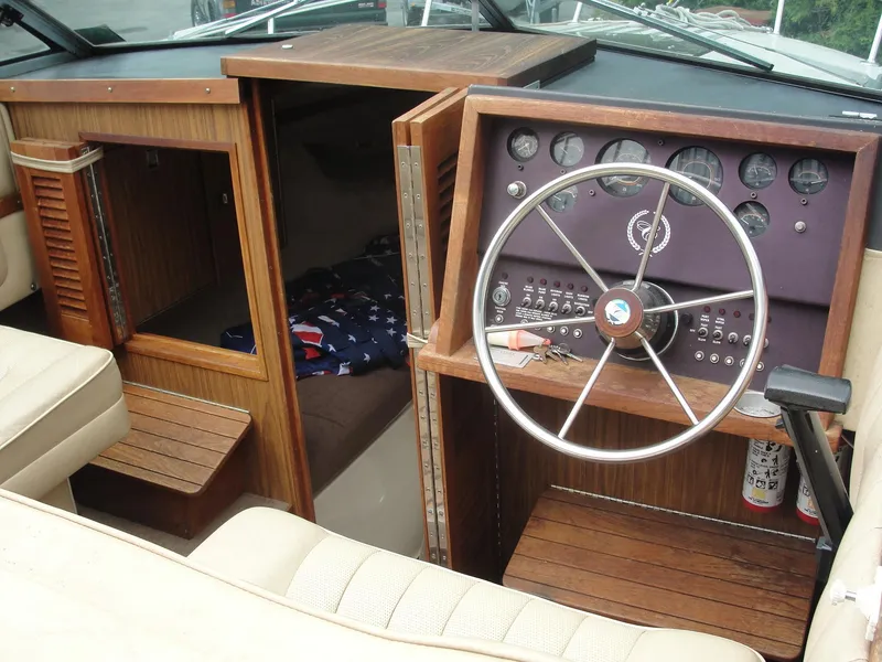 Slide: The Image of 1987 Cobalt Condesa boat interior with wooden dashboard and steering wheel. - 12