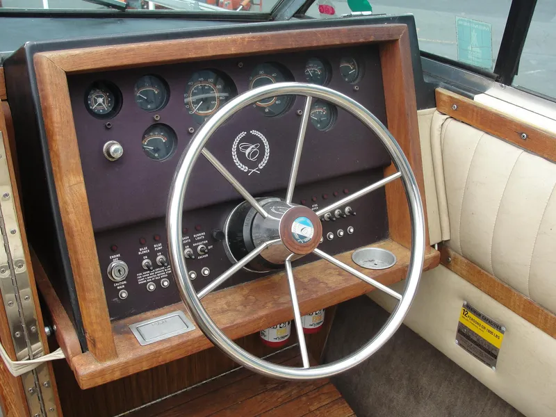 Slide: The Image of 1987 Cobalt Condesa boat dashboard with wooden trim and steering wheel. - 6
