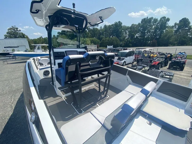 Slide: The Image of 2021 Scarab 255 Open ID boat with seating and console, parked outdoors. - 4