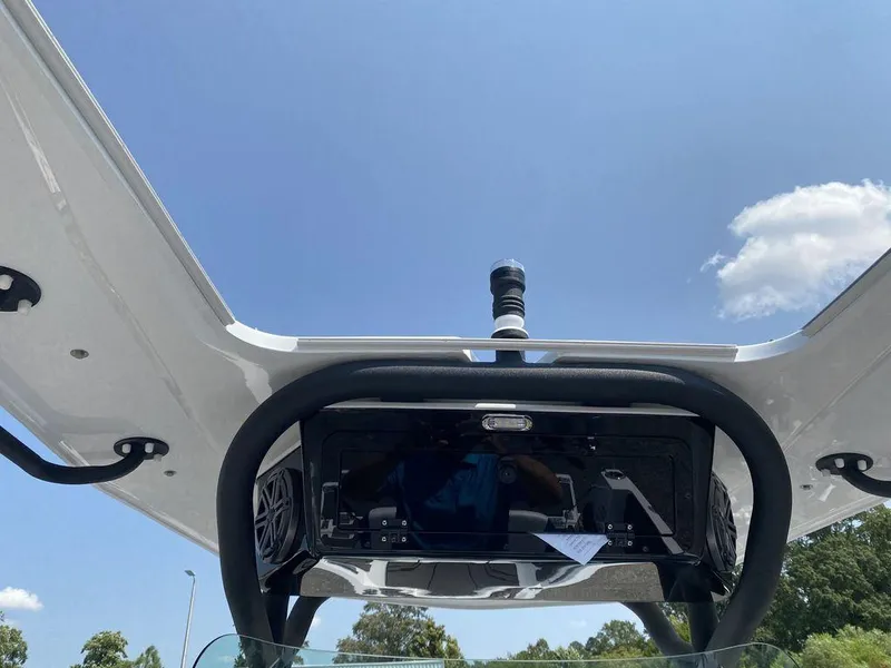 Slide: The Image of 2021 Scarab 255 Open ID boat with T-top and electronics, clear sky background. - 6