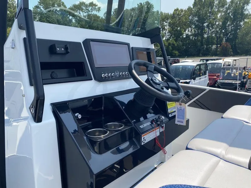 Slide: The Image of 2021 Scarab 255 Open ID boat dashboard with steering wheel and control panel. - 7