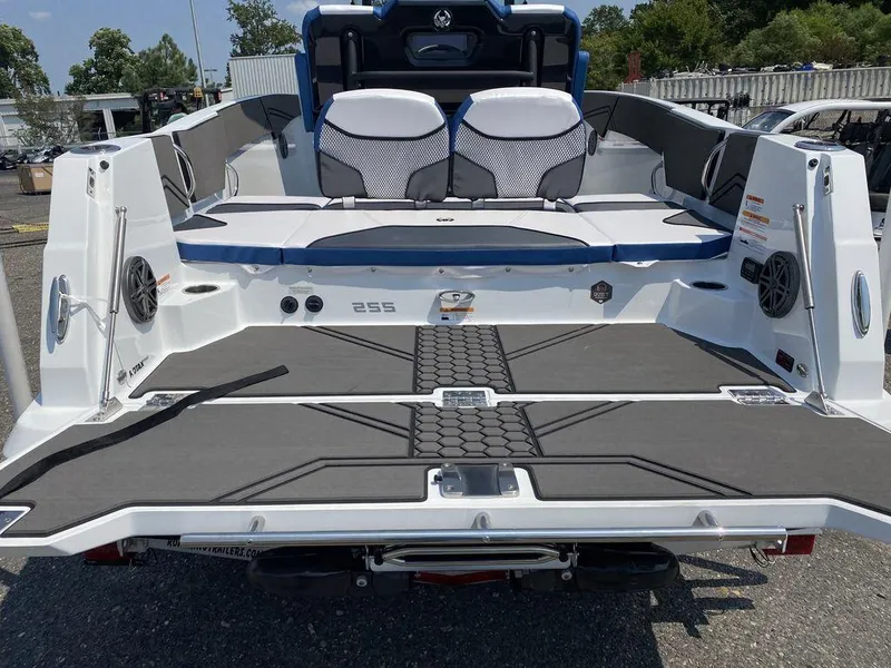 Slide: The Image of 2021 Scarab 255 Open ID boat, rear view, showcasing spacious deck and seating. - 9