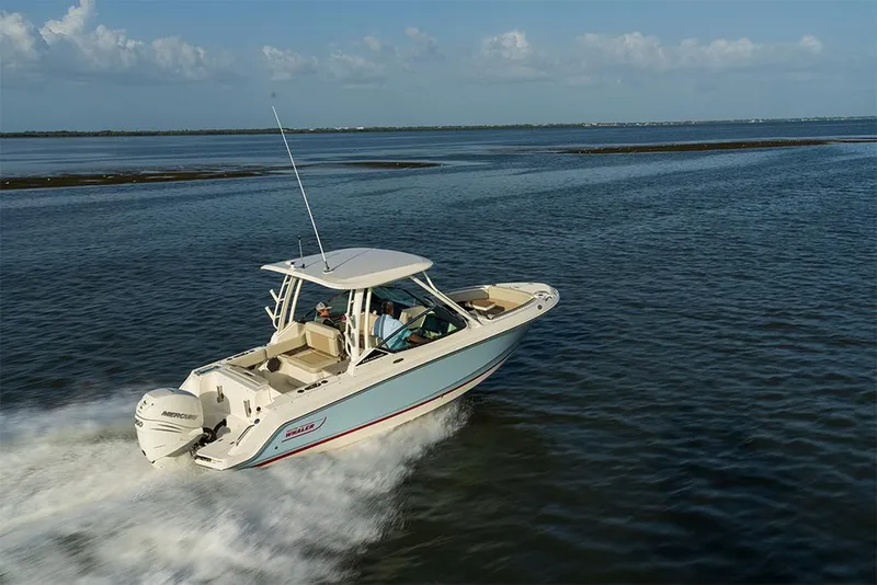 Slide: The Image of 2023 Boston Whaler 240 Vantage cruising on open water. - 20