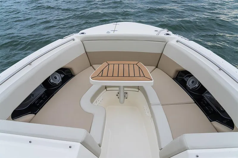 Slide: The Image of 2023 Boston Whaler 240 Vantage boat interior with cushioned seating and table. - 27