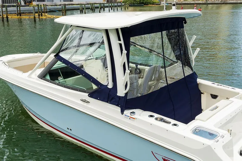 Slide: The Image of 2023 Boston Whaler 240 Vantage boat docked in marina. - 3