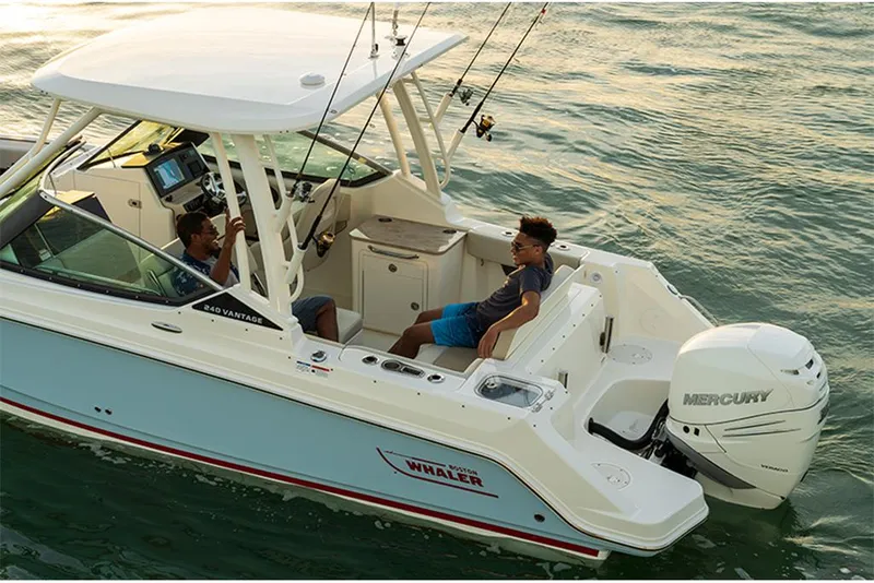 Slide: The Image of 2023 Boston Whaler 240 Vantage boat on water with two people onboard. - 4