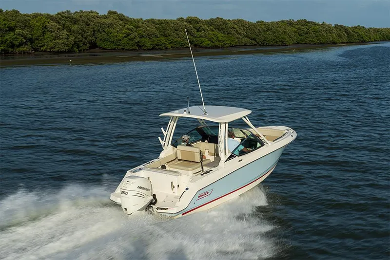 Slide: The Image of 2023 Boston Whaler 240 Vantage boat cruising on a river. - 7