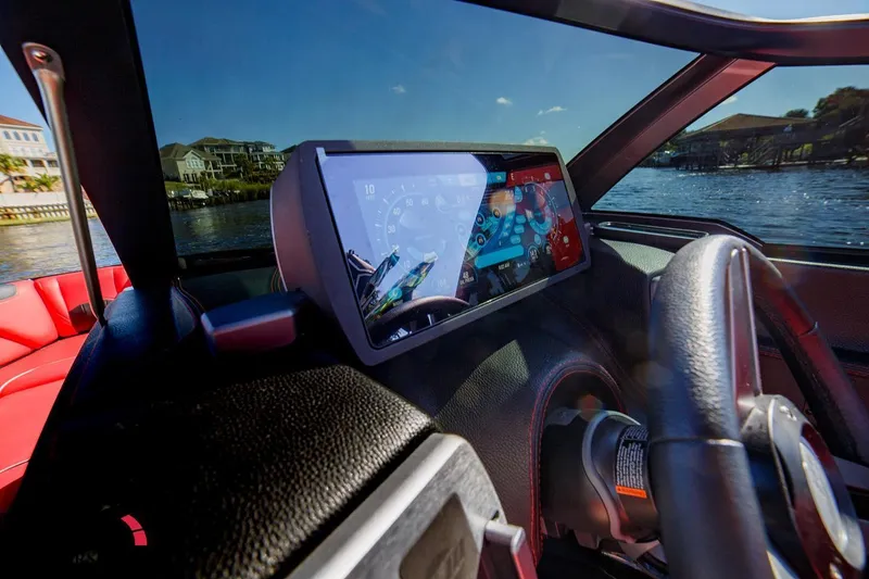 Slide: The Image of 2019 Malibu Wakesetter 25 LSV dashboard with touchscreen display on a sunny day. - 10