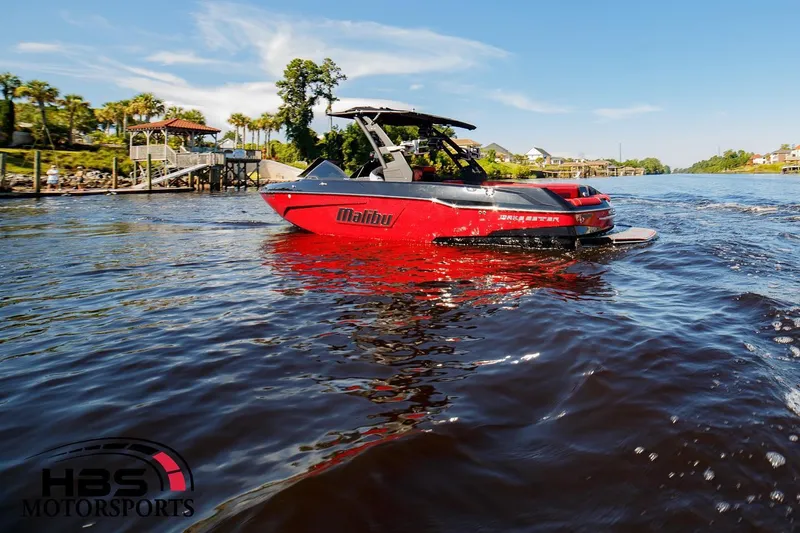 Slide: The Image of 2019 Malibu Wakesetter 25 LSV boat on a sunny day in a scenic waterway. - 3