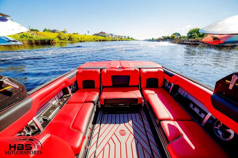 Slide: The Image of 2019 Malibu Wakesetter 25 LSV with red interior on a scenic river. - 6