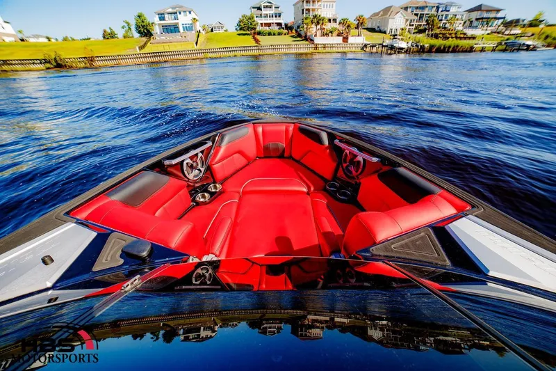 Slide: The Image of 2019 Malibu Wakesetter 25 LSV with red interior on a scenic waterfront. - 8