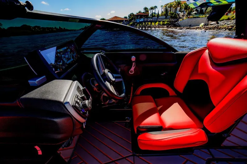 Slide: The Image of 2019 Malibu Wakesetter 25 LSV interior with red seats and modern dashboard. - 9