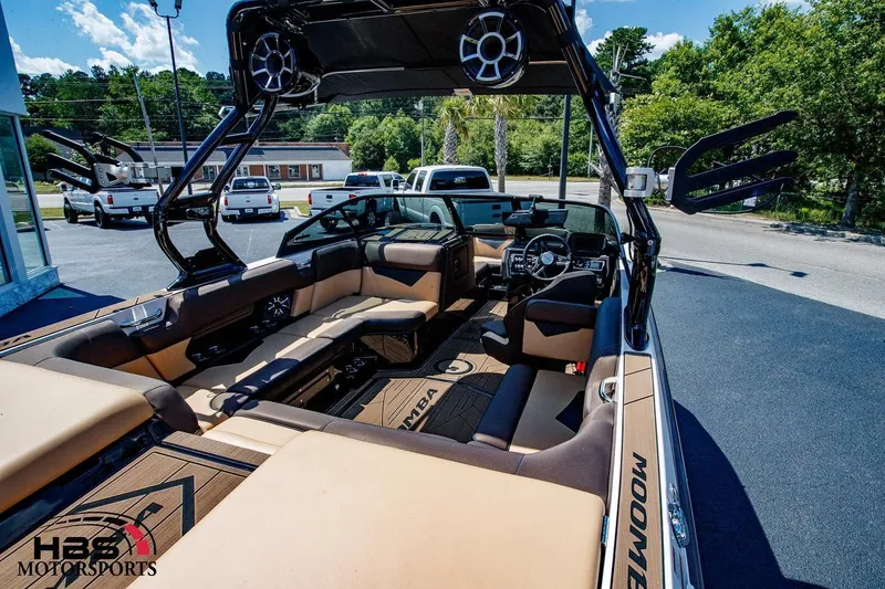 Slide: The Image of 2020 Moomba Kaiyen boat interior with tan seating and advanced audio system. - 10