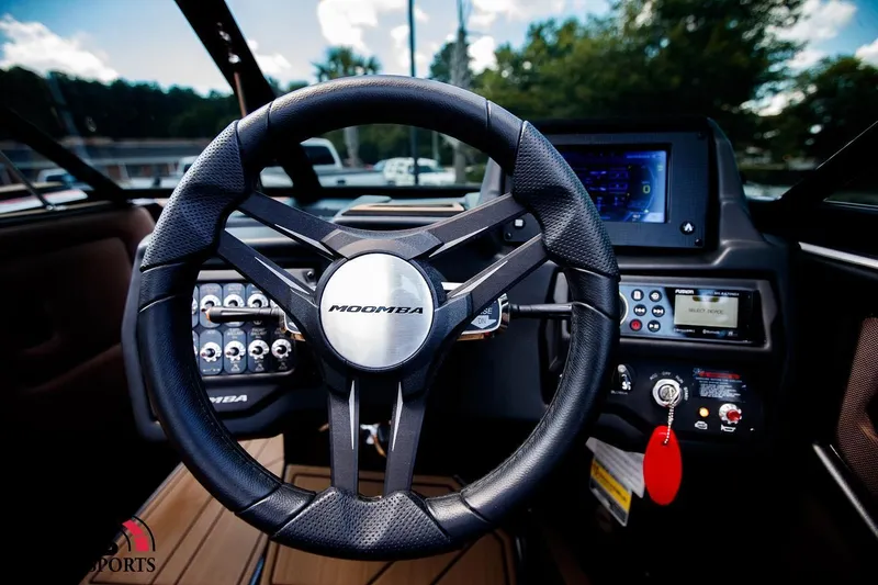 Slide: The Image of 2020 Moomba Kaiyen boat dashboard with steering wheel and control panel. - 9