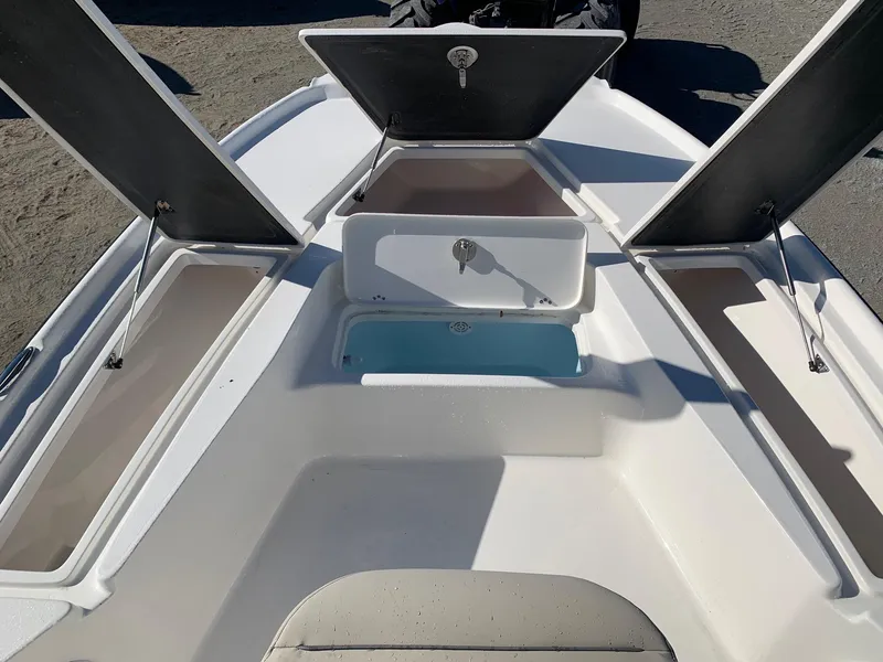 Slide: The Image of 2024 Key West 210 Bay Reef boat storage compartments and seating area. - 17