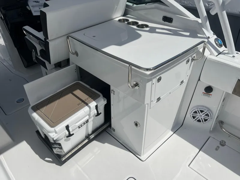 Slide: The Image of 2024 Blackfin 272DC boat interior with storage and cooler. - 12