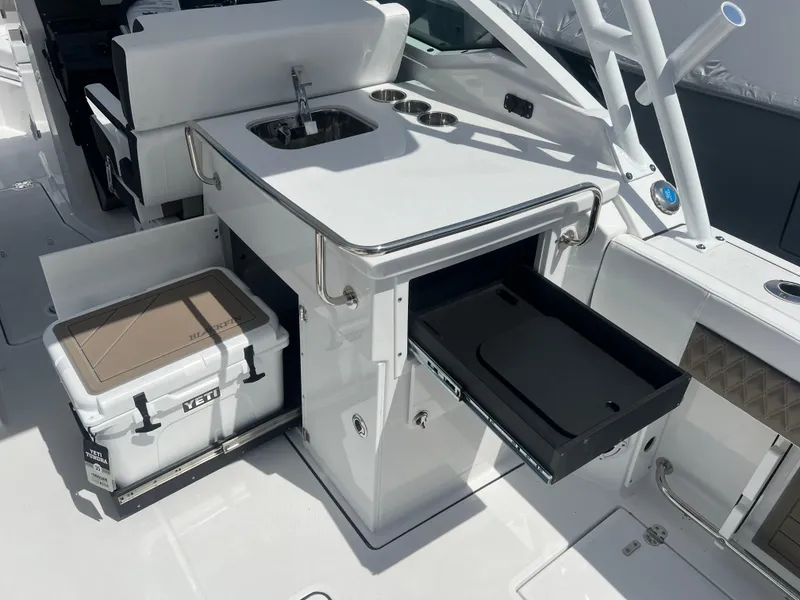 Slide: The Image of 2024 Blackfin 272DC boat with sink, storage drawers, and Yeti cooler. - 13