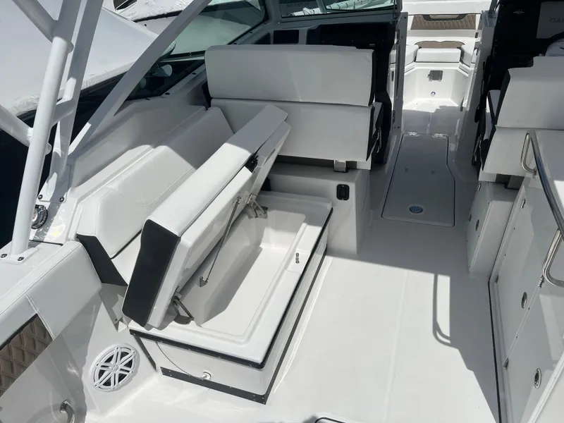 Slide: The Image of 2024 Blackfin 272DC boat interior with white seating and storage compartments. - 15