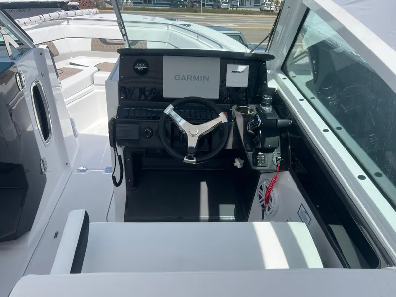Slide: The Image of 2024 Blackfin 272DC boat cockpit with Garmin navigation system. - 16